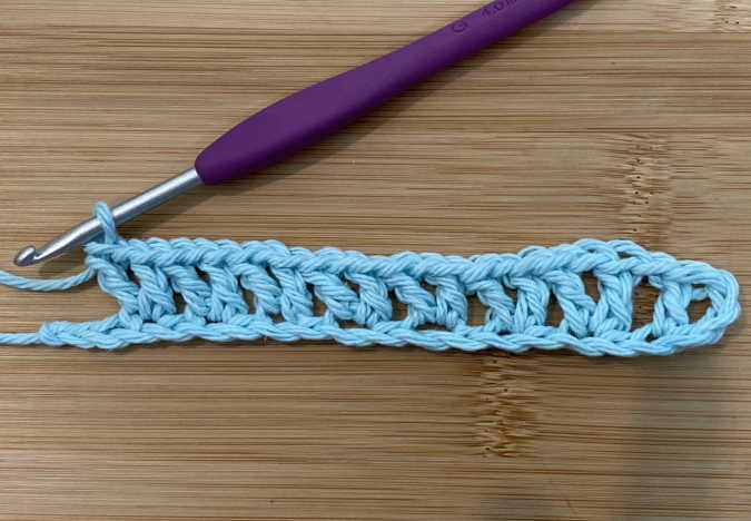 6.  Continue making v stitches by skipping one chain stitch across the row to the end of the row.  (4 chains left).