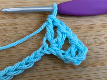 5.  You've just made your first v stitch (one double crochet, one chain, and one double crochet) in the same space.