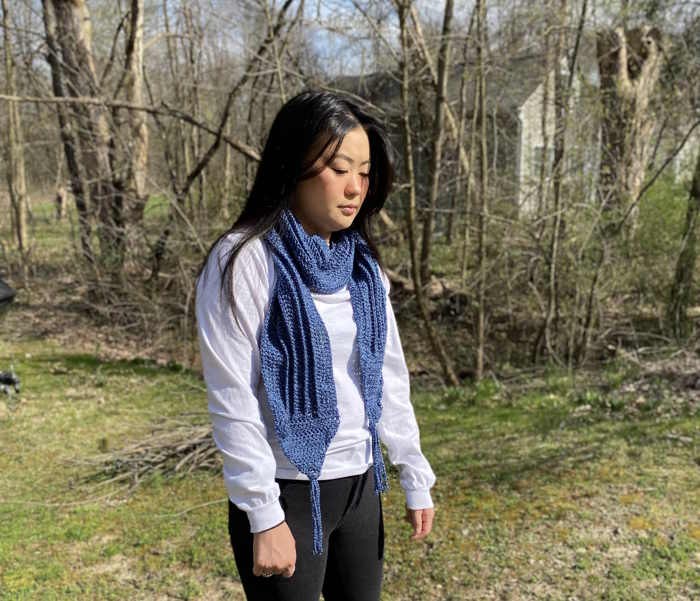 Double crochet scarf in demin yarn modeled by an Asian American model Double crochet scarf in demin yarn modeled by an Asian American model