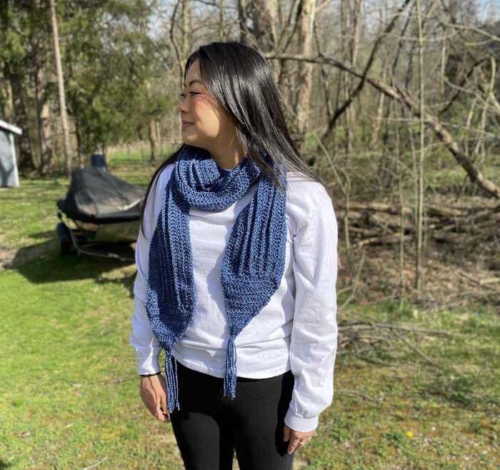Demin yarn creating a double crochet scarf modeled by an Asian American Model in the fall Demin yarn creating a double crochet scarf modeled by an Asian American Model in the fall