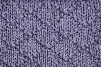 Diamond brocade knit stitch pattern worked in purple thumbnail image