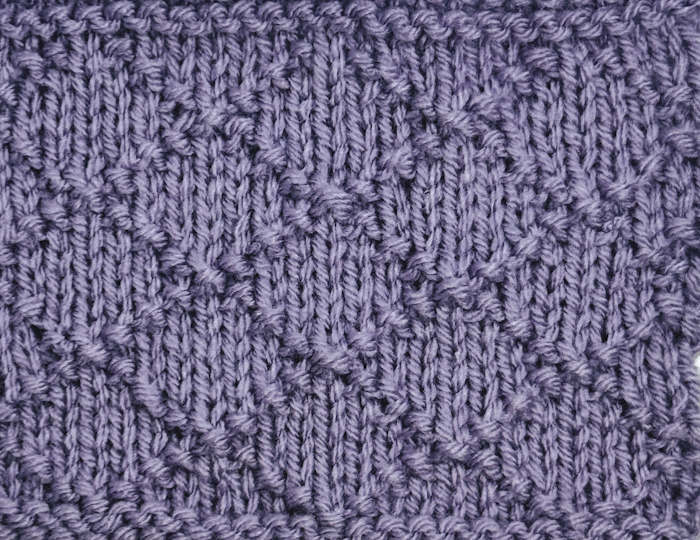 Right side showing of a swatch worked in the diamond brocade stitch pattern.