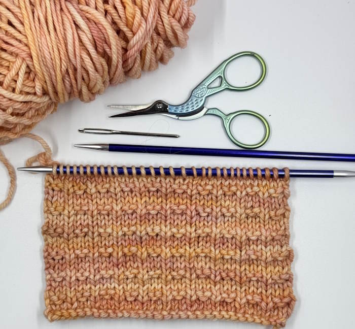 A swatch of the double andalusian knit stitch on needles