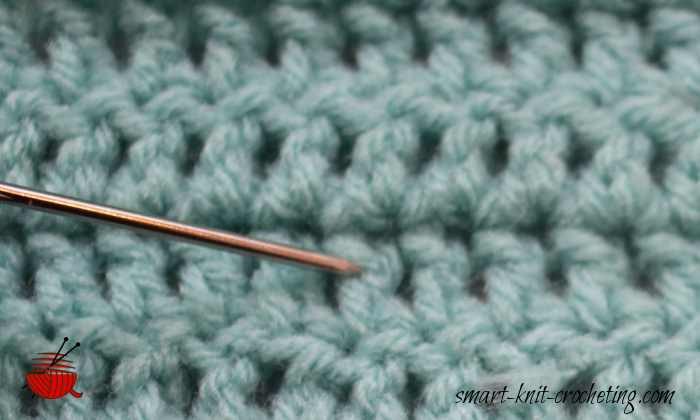 The needle is pointing at one double crochet post or stitch.
