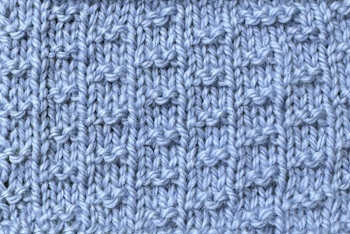 A thumbnail image of the double fleck stitch worked in blue yarn