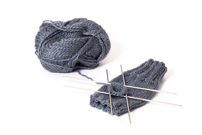 Double pointed needles An example of double pointed knitting needles; set of four needles with yarn and a half finished project