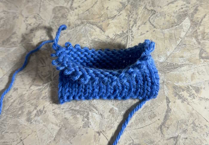 Double stockinette removed from the needle and shown with two layers