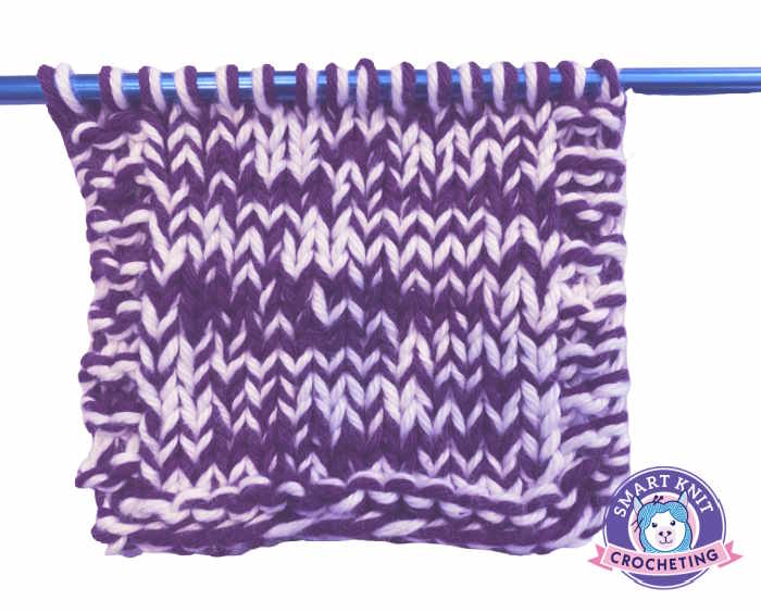 A swatch of stockinette knitting stitch worked with two strands of cotton yarn. A swatch of stockinette knitting stitch worked with two strands of cotton yarn.