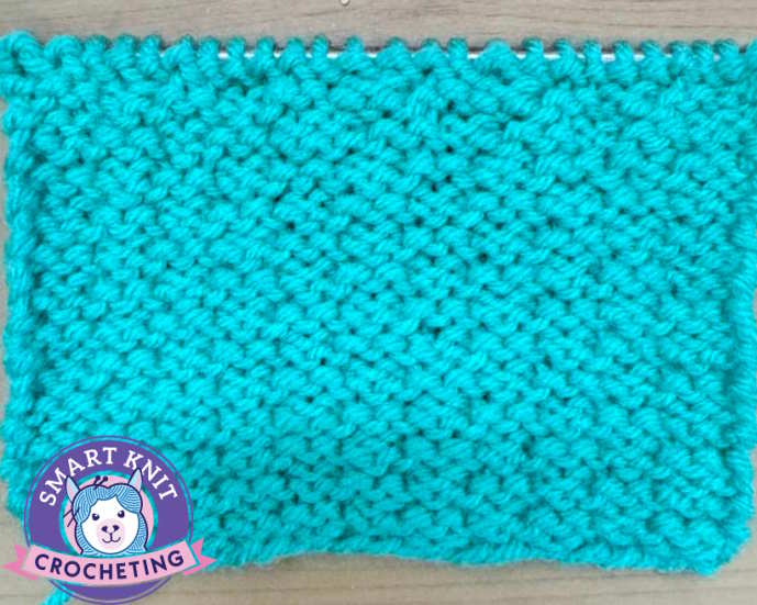 Double woven knit stitch pattern, showing the wrong side and still on needles