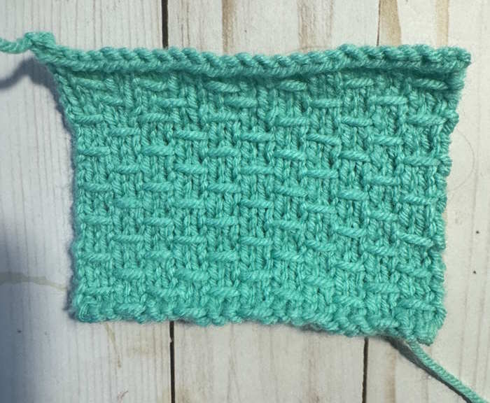 A swatch of the double woven knit stitch worked in a teal color