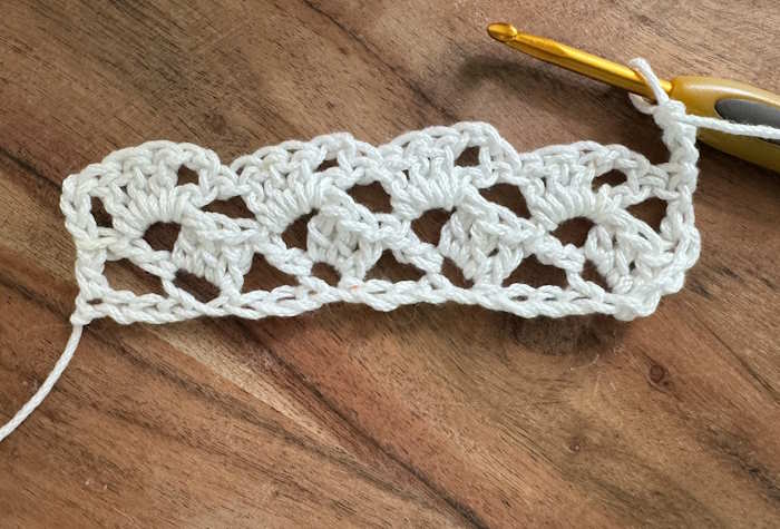 The Crochet Drunken Granny Stitch: Row Two Row two of the Crochet Drunken Granny Stitch Pattern worked in white cotton.