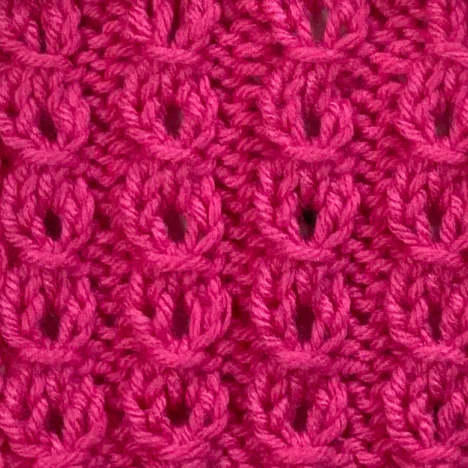 Mock eyelet cable stitch worked in bright pink
