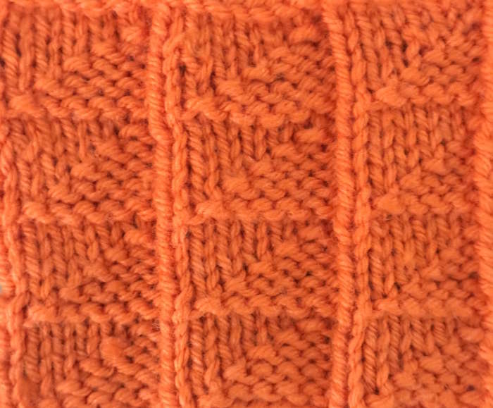 flag stitch close up using orange acrylic yarn