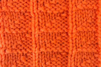 Thumbnail photo of the Knit Flag Stitch worked in orange yarn
