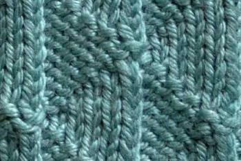 The knit  Flying Geese pattern worked in dark teal