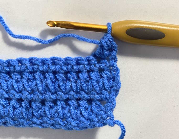 Part of a stitch tutorial showing the forked half double crochet stitch complete