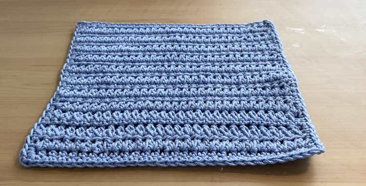 A forked half double crochet washcloth worked in 100% cotton