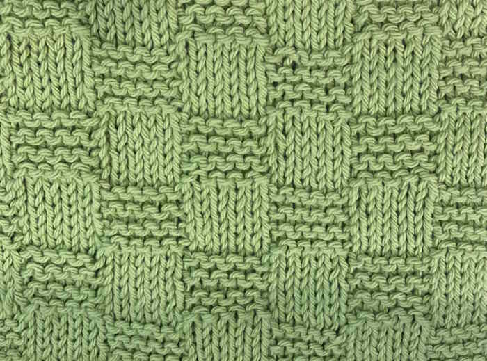 A swatch showing the garter checkerboard stitch done in green