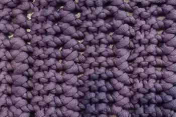 The knit garter lace stitch pattern worked in purple.