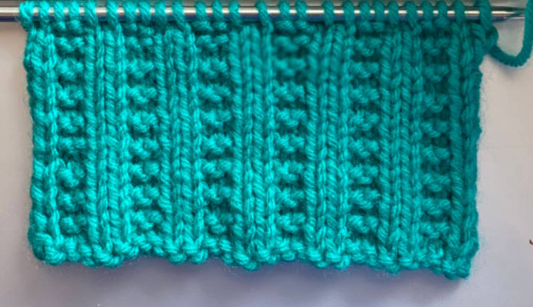 Garter rib stitch pattern worked in green, right side facing.