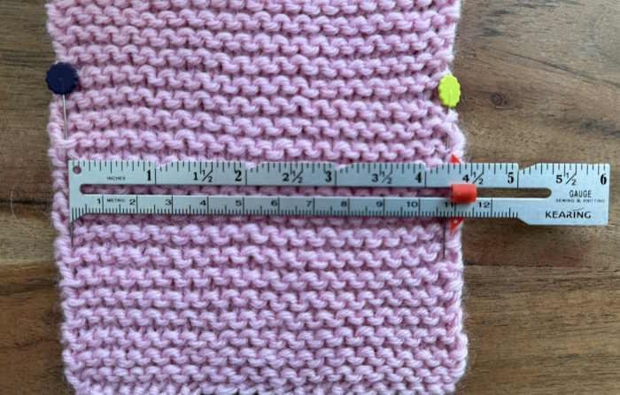 A garter stitch swatch with a ruler measuring gauge A garter stitch swatch with a ruler measuring gauge