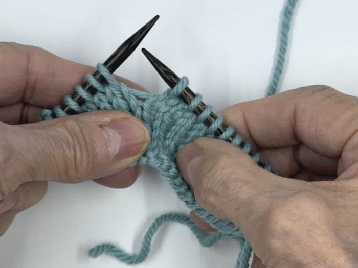 step one for working the german short row technique on the knit side of the fabric