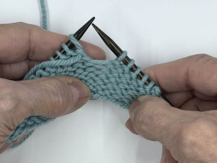 Step two when working the german short row technique on the knit side of the fabric