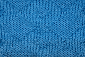 A swatch of the giant diamond worked in blue yarn, thumb image