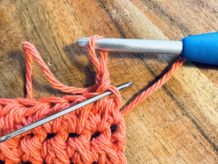 Swatch of the half double crochet cluster showing where to place the first stitch. Swatch of the half double crochet cluster showing where to place the first stitch.