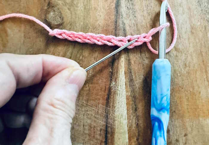 A crochet chain identifying with a needle the second chain from the hook