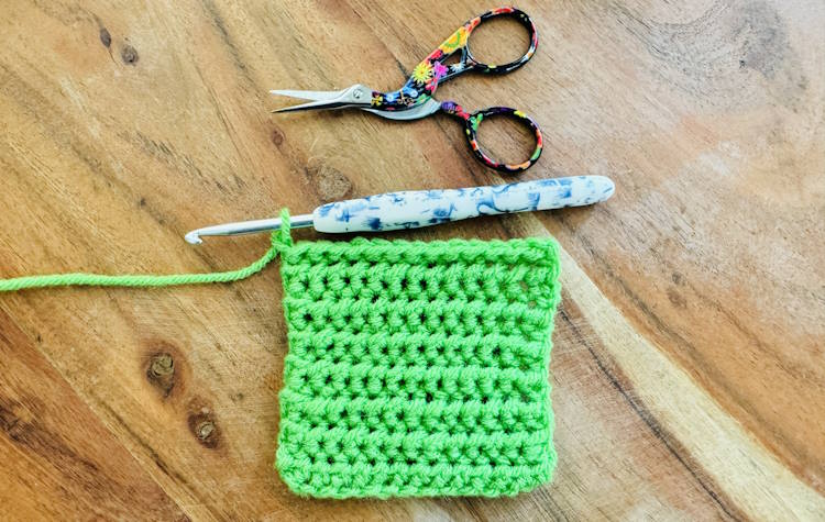 Right side of the half double crochet slip stitch worked in green yarn.