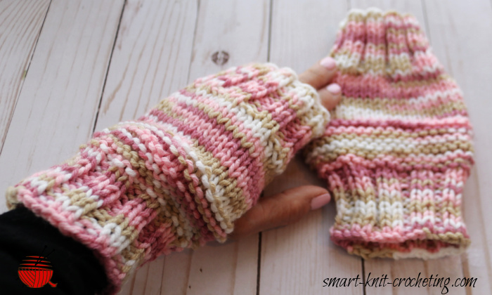 Two knit hand mitts, one being worn