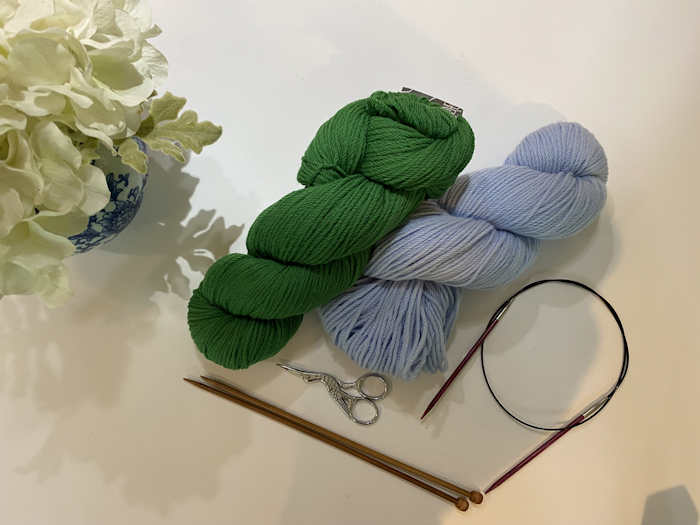 Two hanks of yarn in green and blue