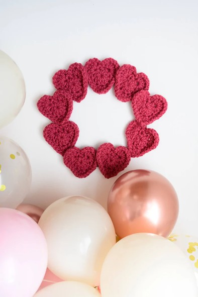 A heart shaped wreath crocheted in pink yarn A heart shaped wreath crocheted in pink yarn