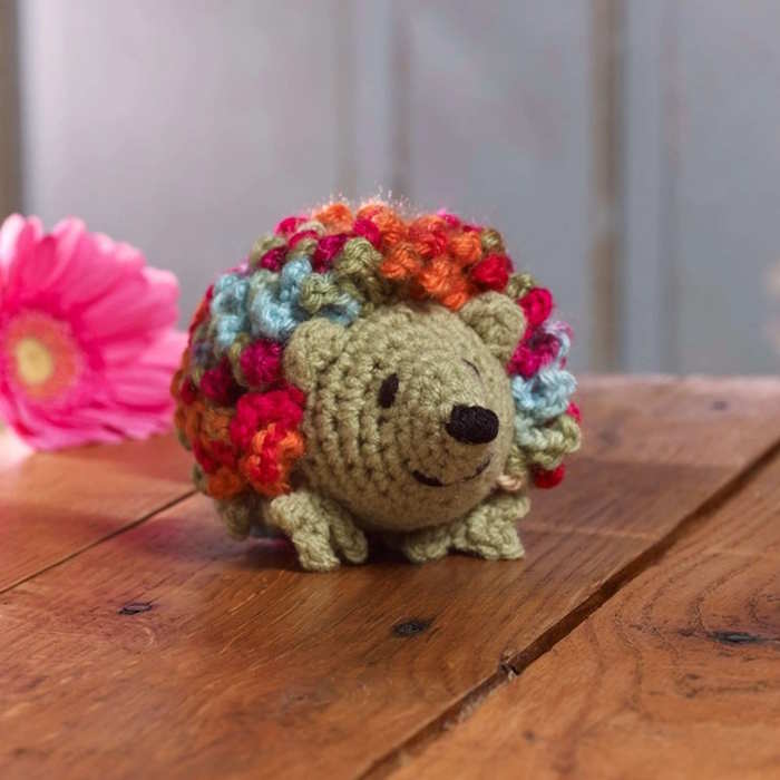 An intermediate crochet hedgehog toy worked in colorful yarn