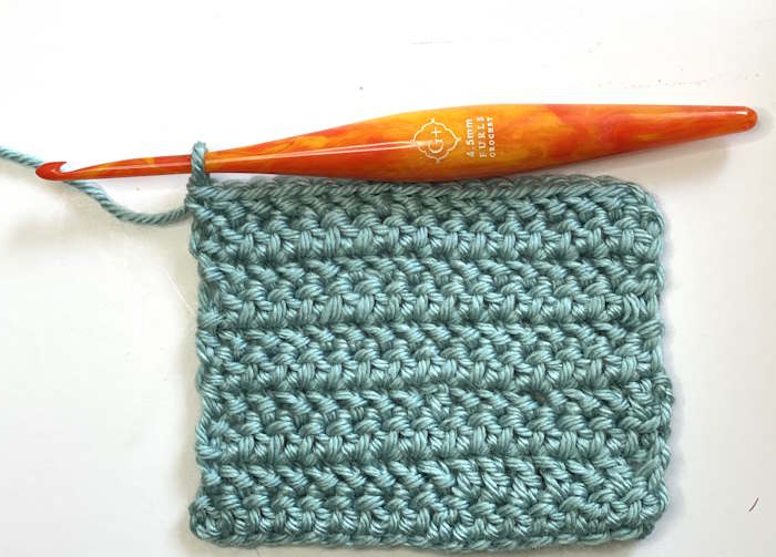 The herringbone crochet stitch worked into a teal colored swatch