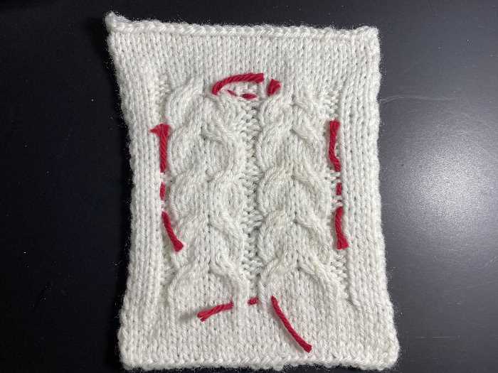 Knit a Cable:  Horseshoe Cable The horseshoe cable pattern worked in white yarn.