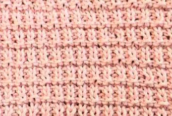 The knit hurdle stitch pattern made with pink yarn. The knit hurdle stitch pattern made with pink yarn.