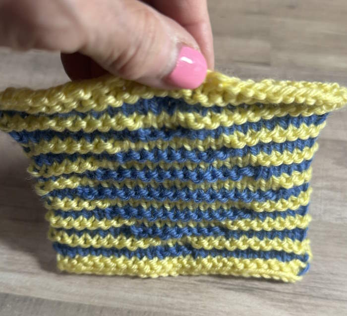 A swatch of illusian knitting shown at an angle