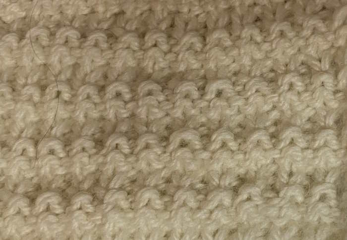 The wrong side showing of the interrupted rib stitch