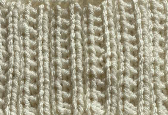 The Iron knit stitch pattern worked in white yarn, right side