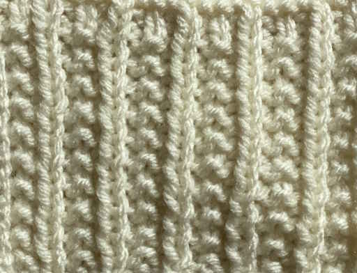 Iron knit stitch swatch worked in white yarn, wrong side