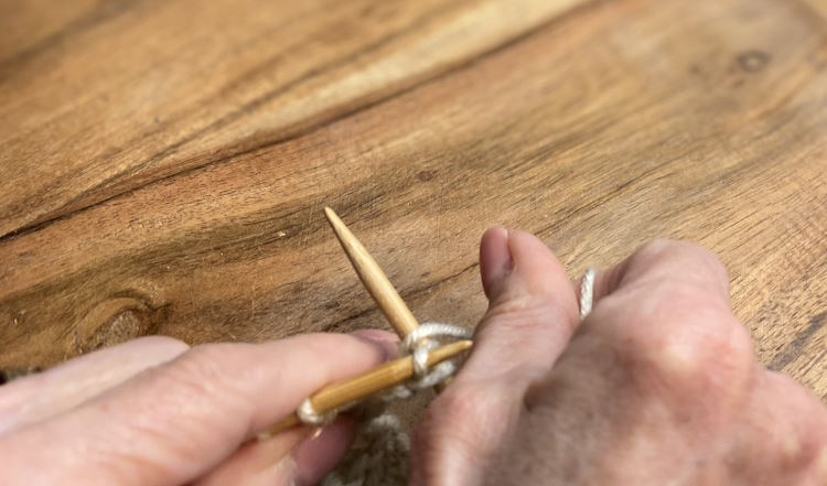 Step five of the step-by-step tutorial on how to make the KFB (knit, front, back)