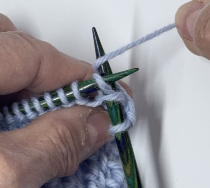Step 3 of how to do a knit one below