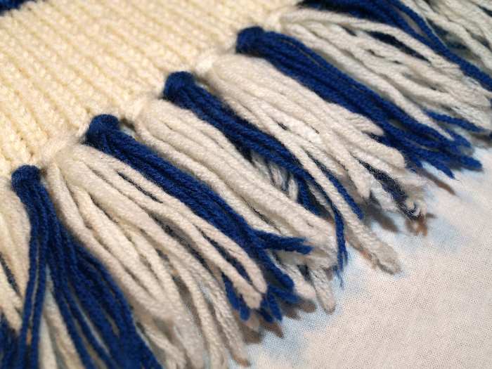 A Knit Scarf made with blue and white yarn