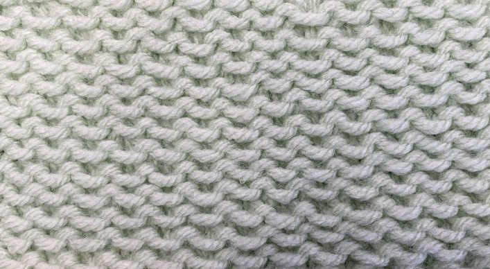 The knit stamen stitch worked in a light green cotton yarn, showing the right side