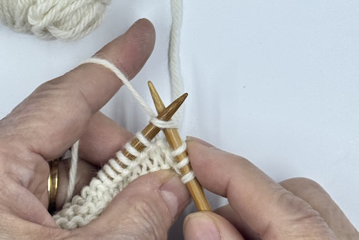 The first step of four for making the knit stitch in the continental style.