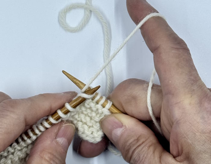 Step two for making the knit stitch English Style is to wrap the yarn around the right needle