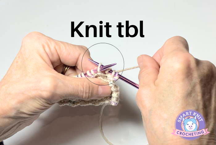 Two hands knitting:  Demonstrating how to knit tbl (through the back loop) Two hands knitting:  Demonstrating how to knit tbl (through the back loop)