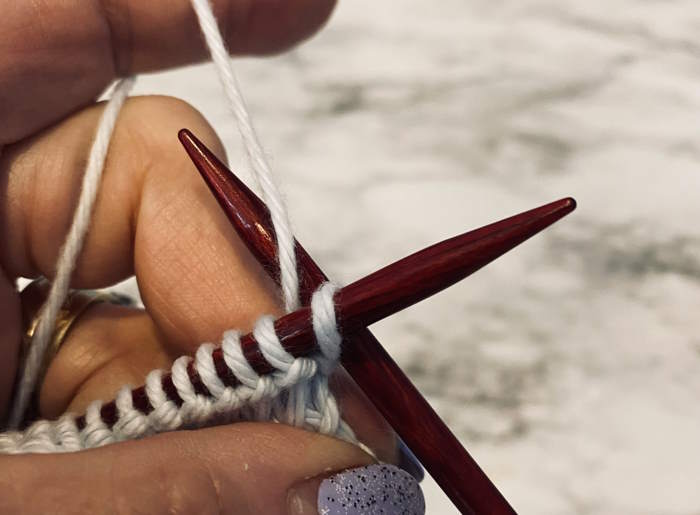 Demonstration on how to knit through the back loop of a stitch. Demonstration on how to knit through the back loop of a stitch.